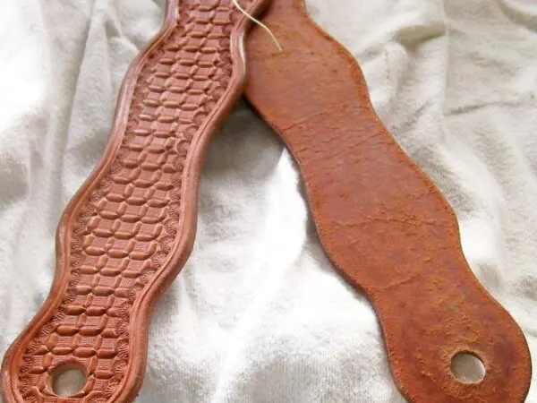 Leather and rusted metal straps on fabric