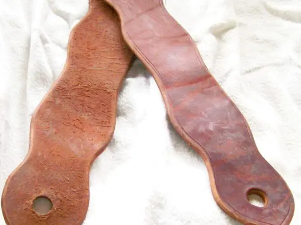 Leather shoe insoles on white fabric