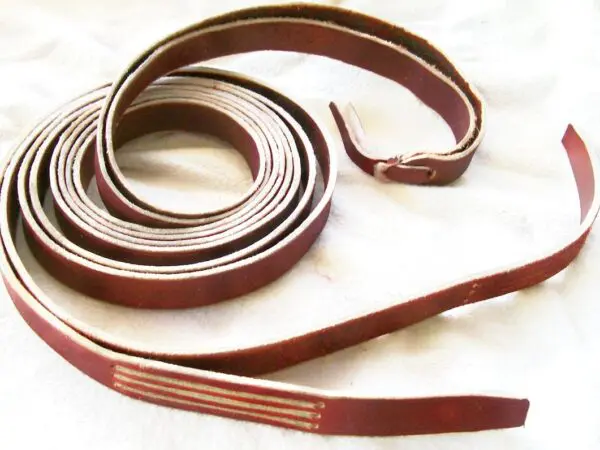 Coiled leather strap on white background