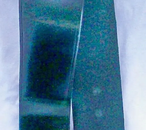Shiny black belt on white background