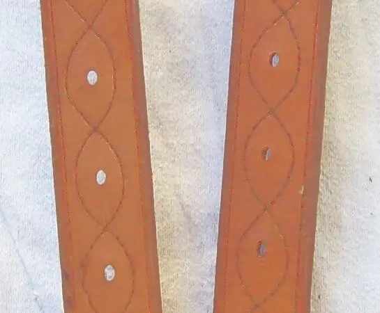 Brown leather straps on white cloth
