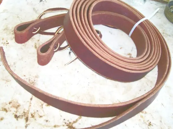 Rolled leather belts on surface
