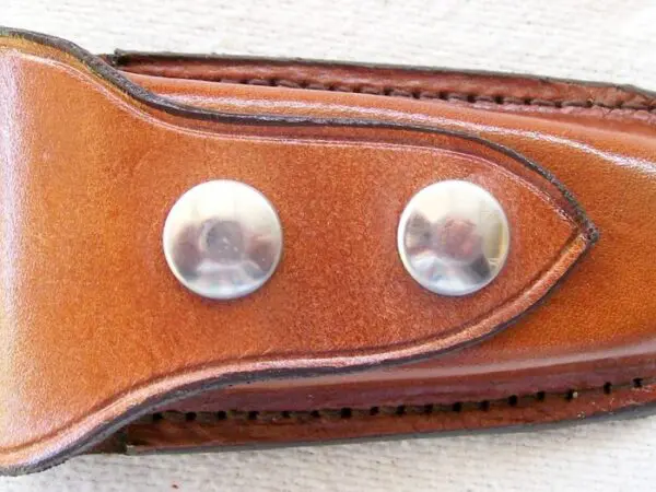 Tan leather accessory with metal studs