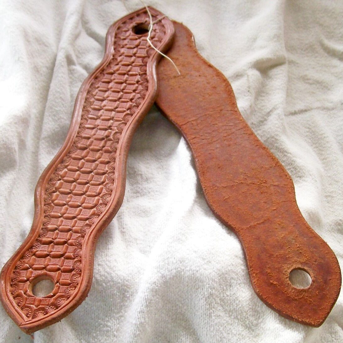 Leather and rusted metal straps on fabric