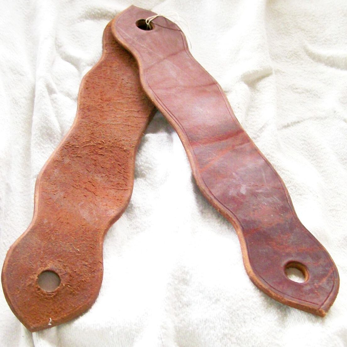 Leather shoe insoles on white fabric