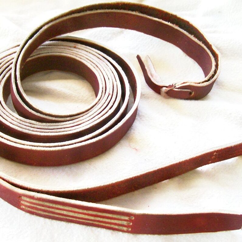 Coiled leather strap on white background