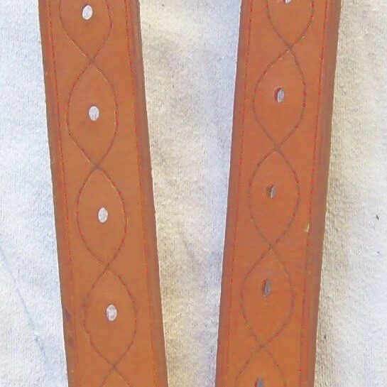 Brown leather straps on white cloth
