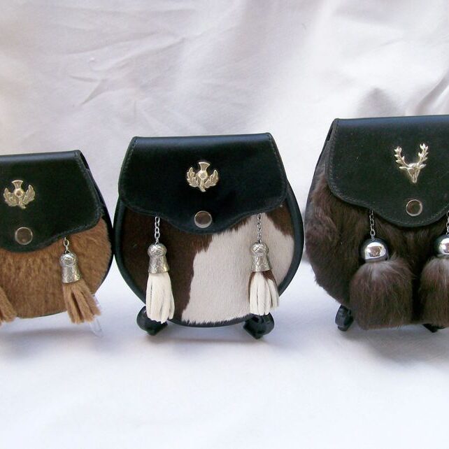 Three traditional Scottish sporrans displayed