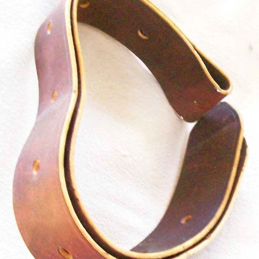 Curved leather belt with holes