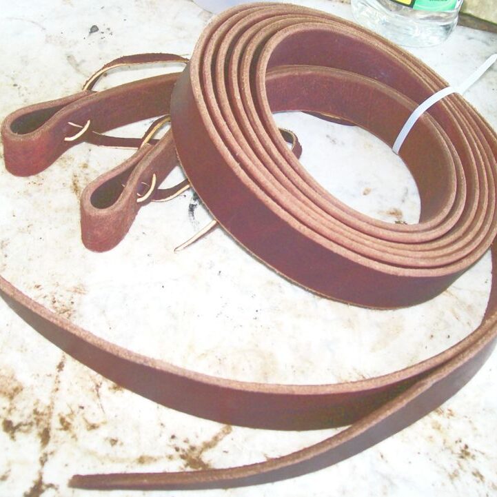 Rolled leather belts on surface
