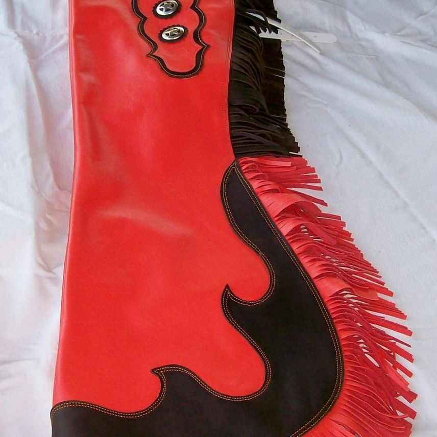 Decorative cowboy chaps on fabric background