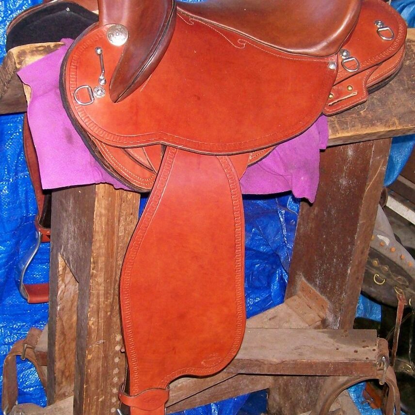 Leather saddle on wooden stand