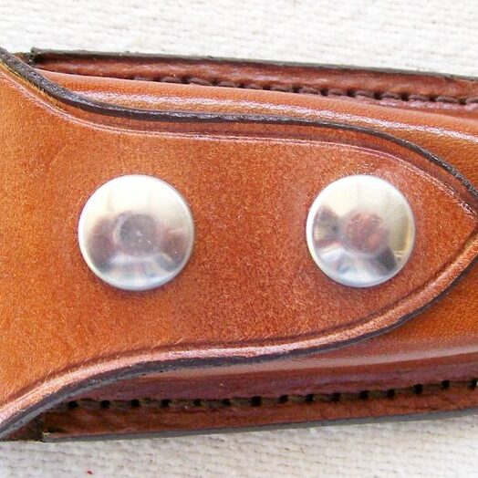 Tan leather accessory with metal studs